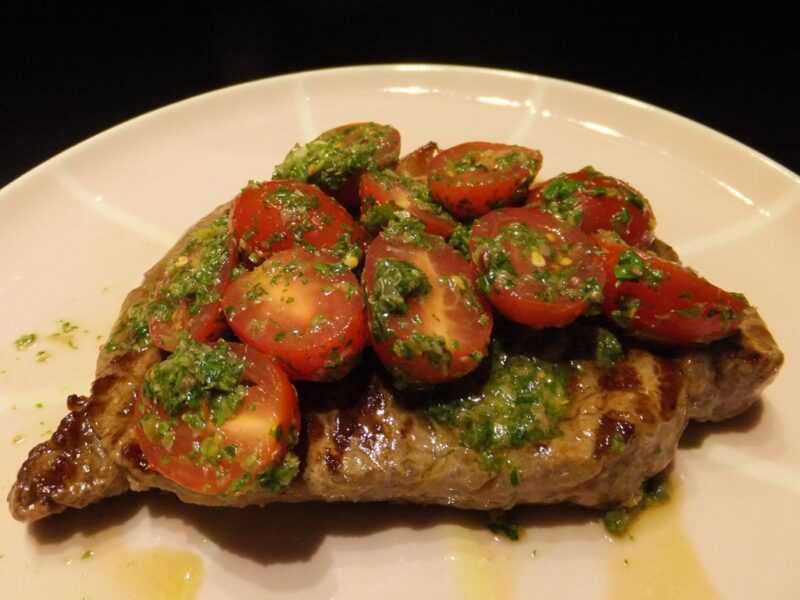 Steak with salsa verde and tomatoes