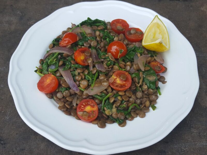 Warm lentil, tomato and spinach salad