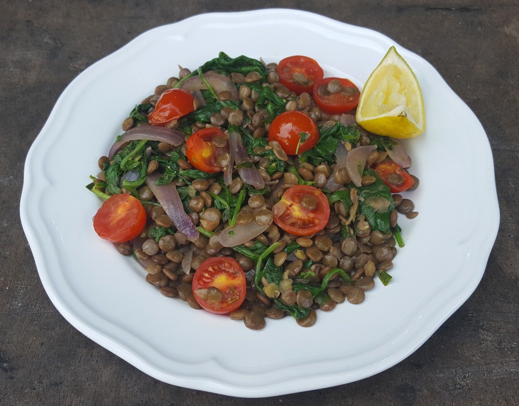 Warm lentil, tomato and spinach salad