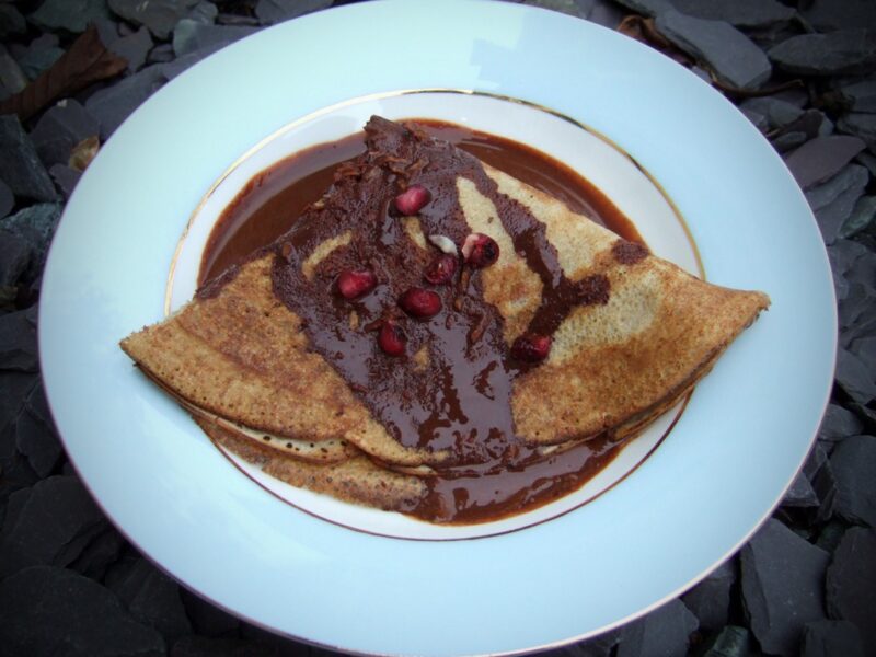 Pomegranate crepes with zesty chocolate sauce