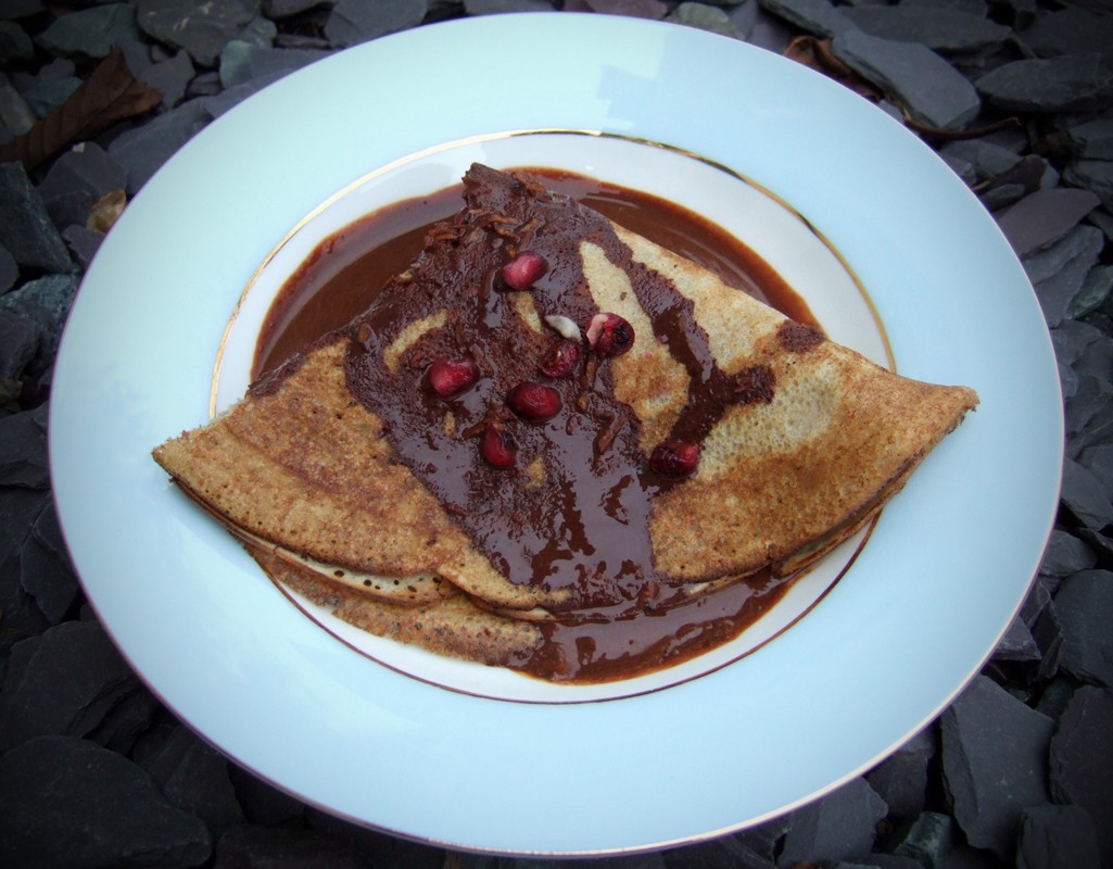 Pomegranate crepes with zesty chocolate sauce