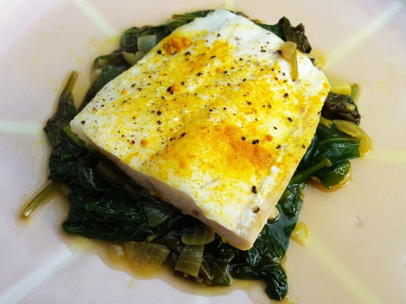 Braised haddock with spiced spinach