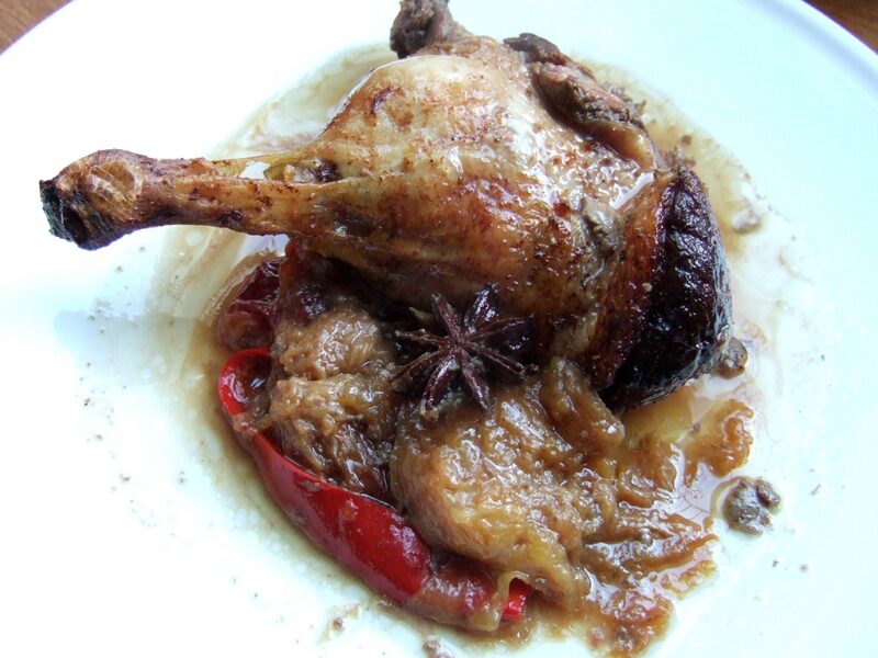 Baked spiced duck legs with plums