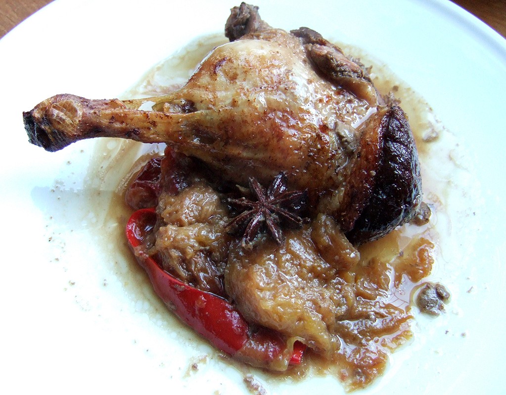 Baked spiced duck legs with plums