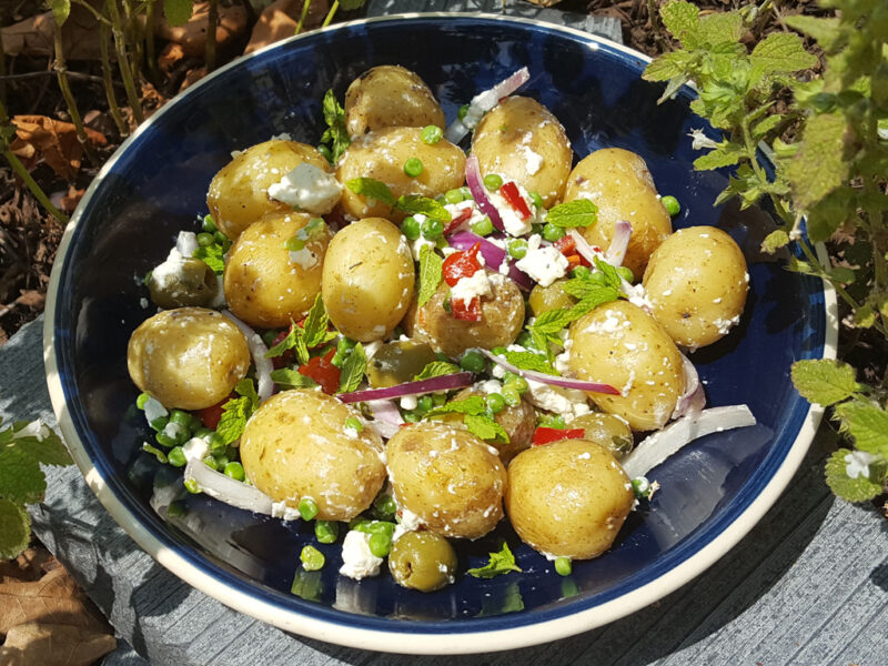 Potato salad with green peas and feta