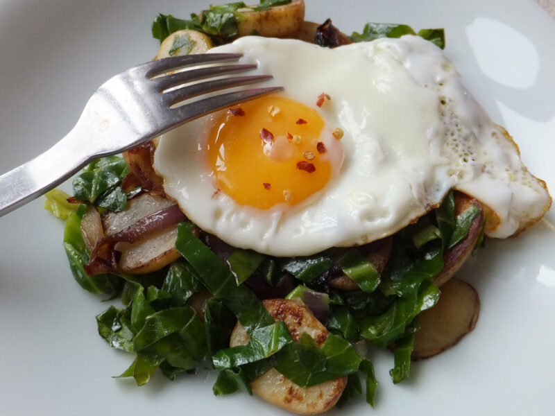 Fried eggs with cabbage and potatoes