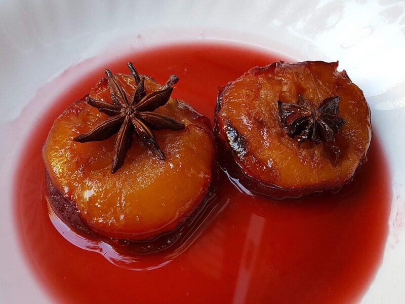 Baked plums in cherry sauce