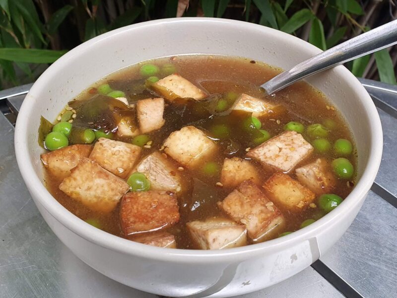 Vegan miso soup with peas and baked tofu