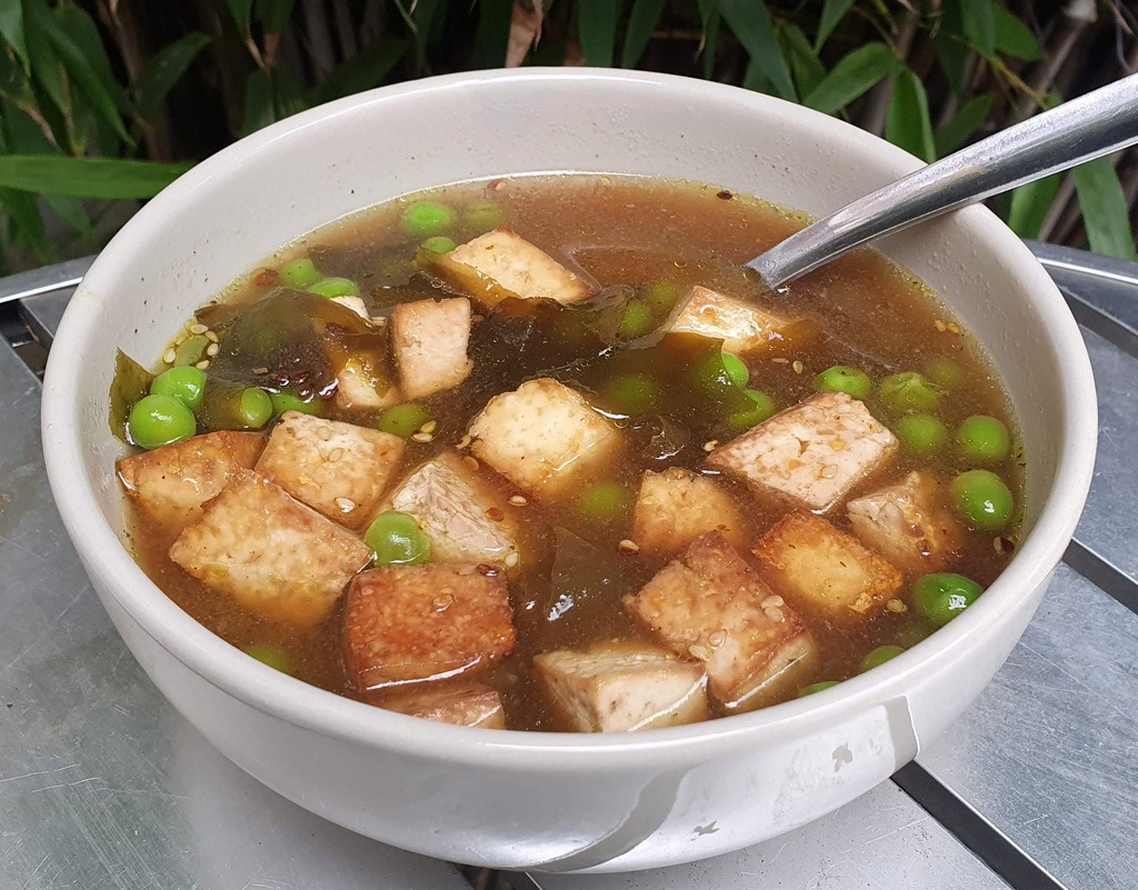 Vegan miso soup with peas and baked tofu