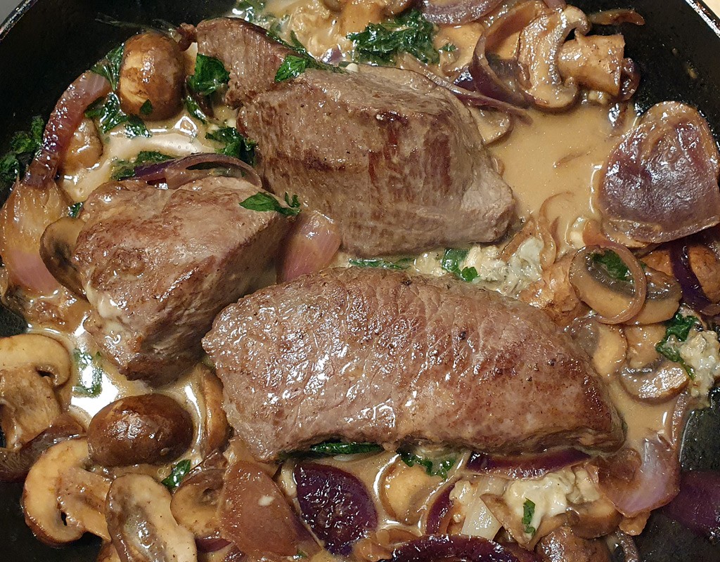 Venison steak with mushroom and blue cheese sauce