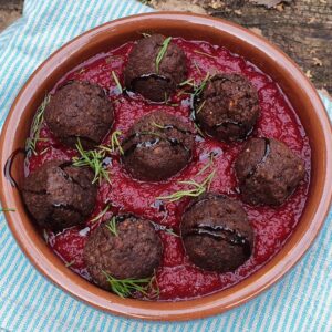 Vegan meatballs in baked beetroot & red pepper sauce