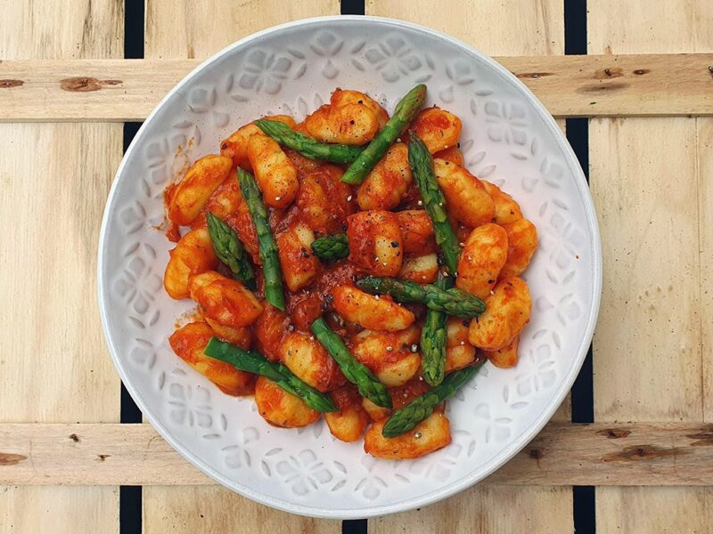 Gnocchi and asparagus in red pepper & tomato sauce