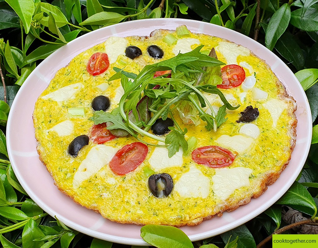 Courgette frittata with cheese and tomato