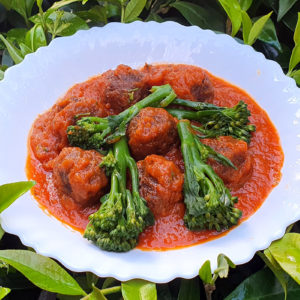 Meatballs with broccoli in red pepper sauce