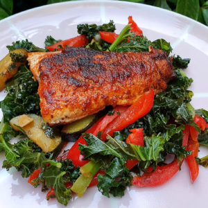 Salmon with sautéed kale and courgette