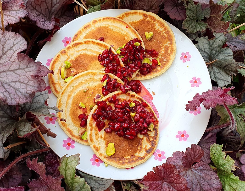 Orange pancakes with pomegranate and pistachio