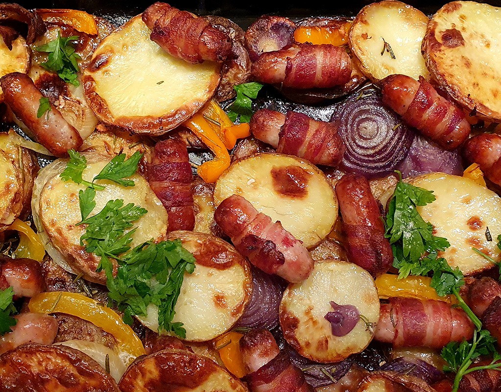 Potato bake with pigs in blankets