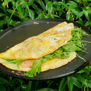 Smoked salmon omelette with spring onion and rocket