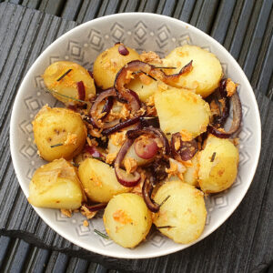 New potatoes with salmon and caramelised onion