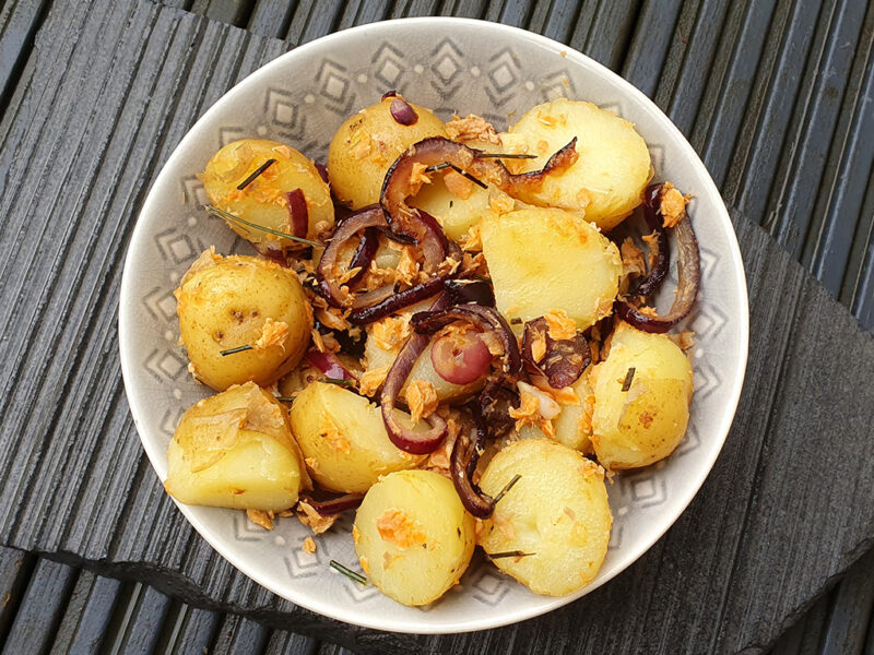 New potatoes with salmon and caramelised onion