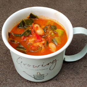 Tomato soup with beans and spring greens