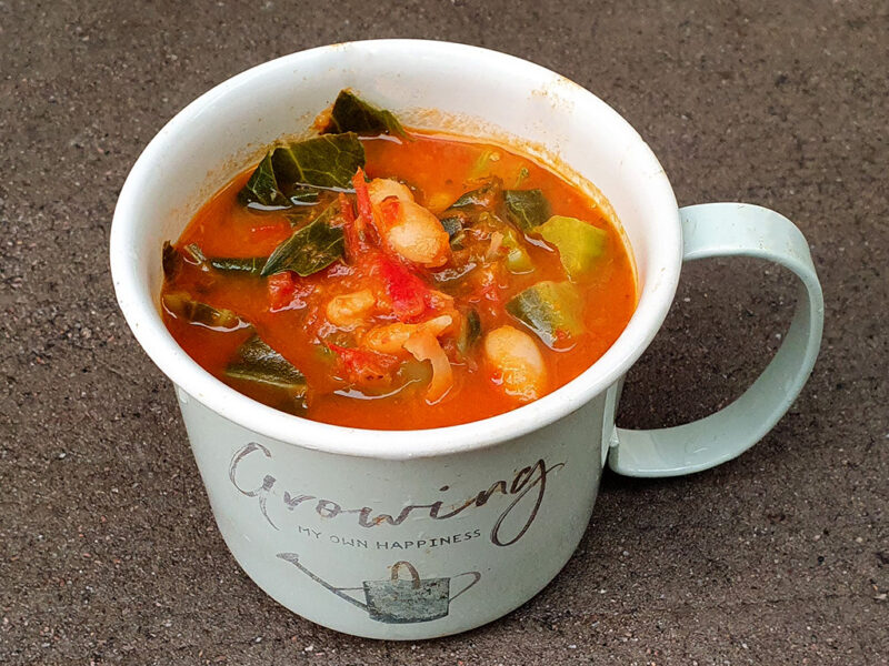 Tomato soup with beans and spring greens