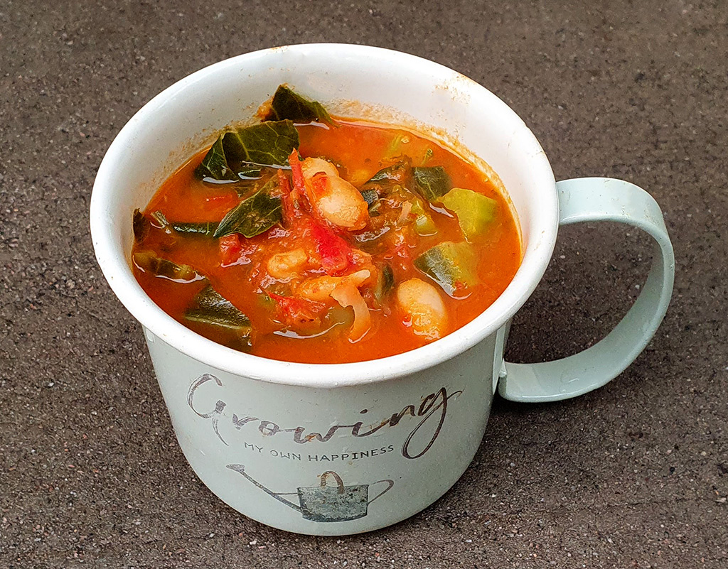 Tomato soup with beans and spring greens
