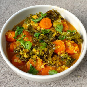Spiced carrot and red lentil soup with kale