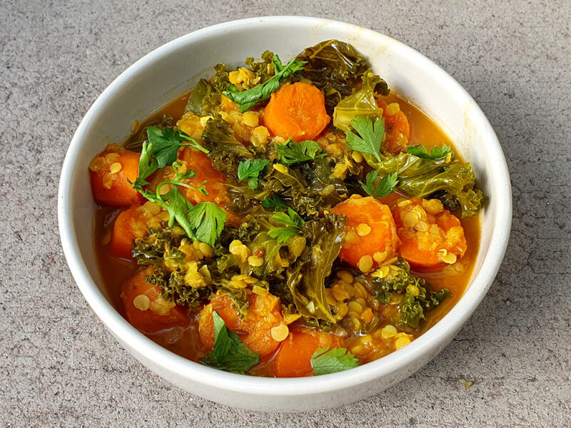 Spiced carrot and red lentil soup with kale
