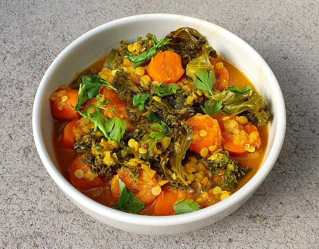 Spiced carrot and red lentil soup with kale